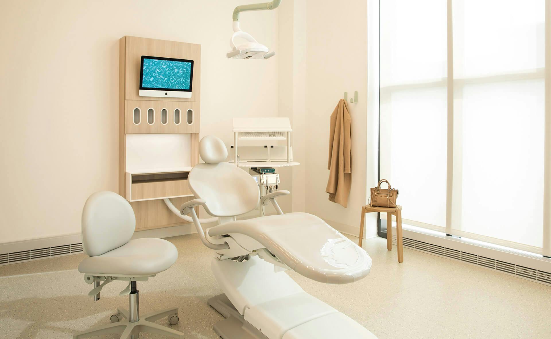 Dental chair and tv screen in Tend dental studio