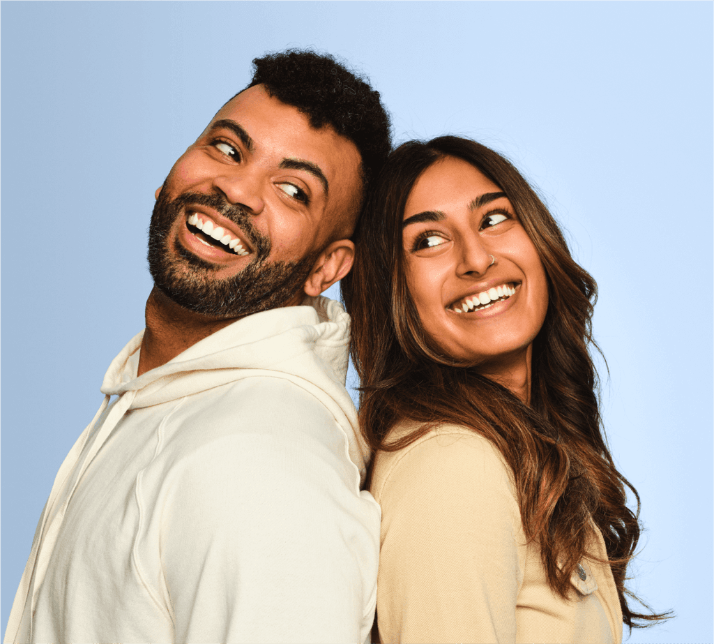 man-and-woman-back-to-back-smiling