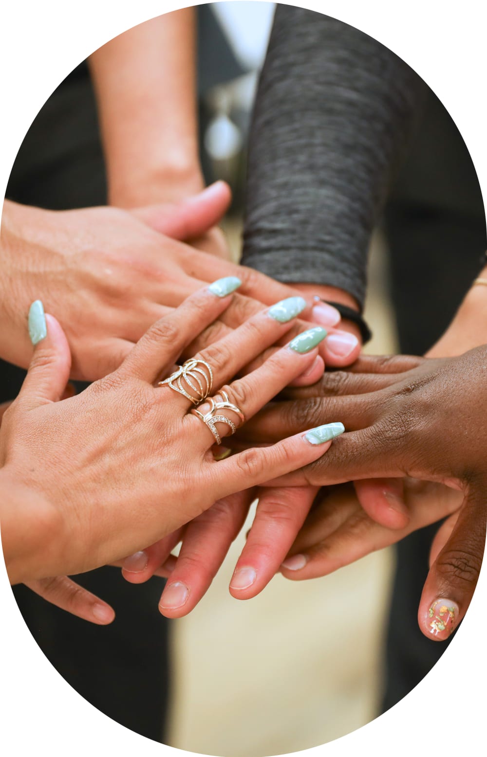 Team members from Tend Dental have their hands together in a cheer.