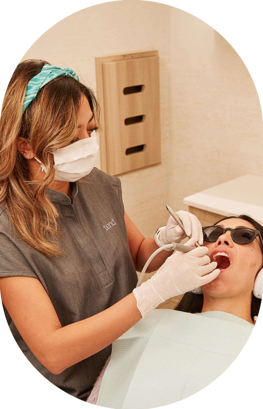 A dental hygienist at Tend Dental works on a patient.