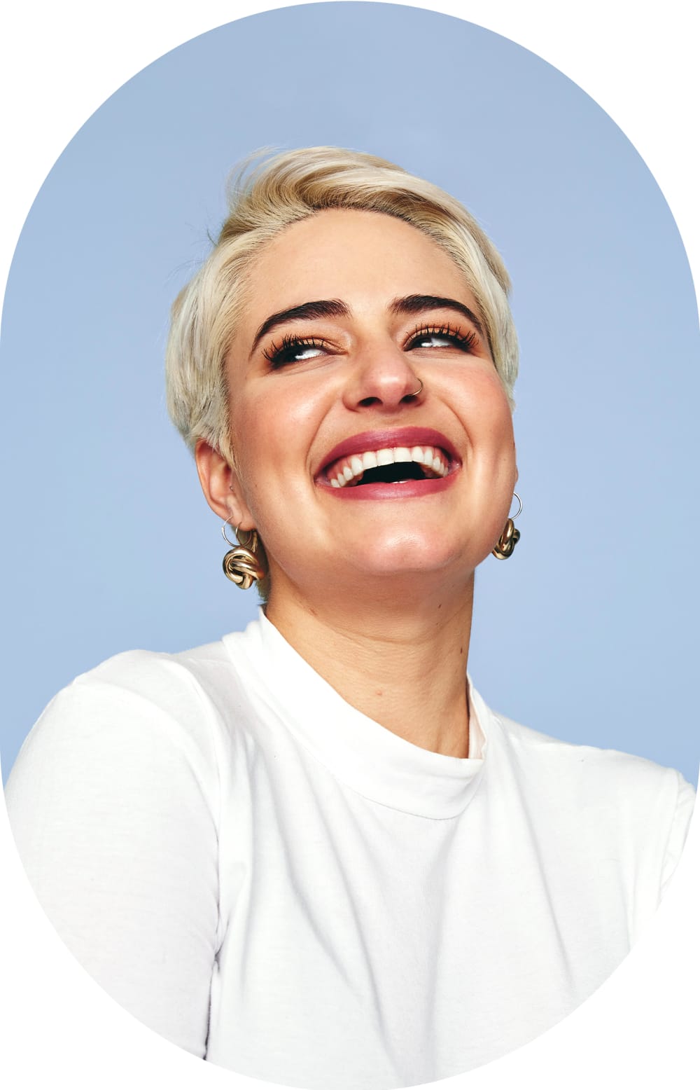 Smiling woman with short hair looking up to the right.
