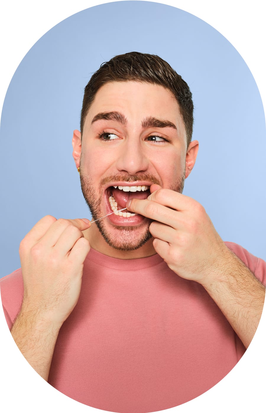 A man is flossing his teeth.