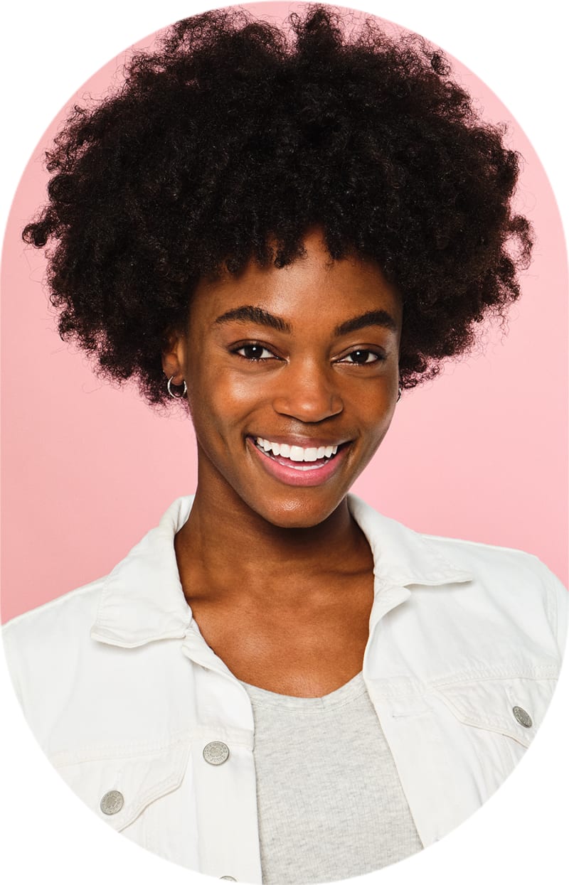 Smiling woman with curly hair and a white shirt