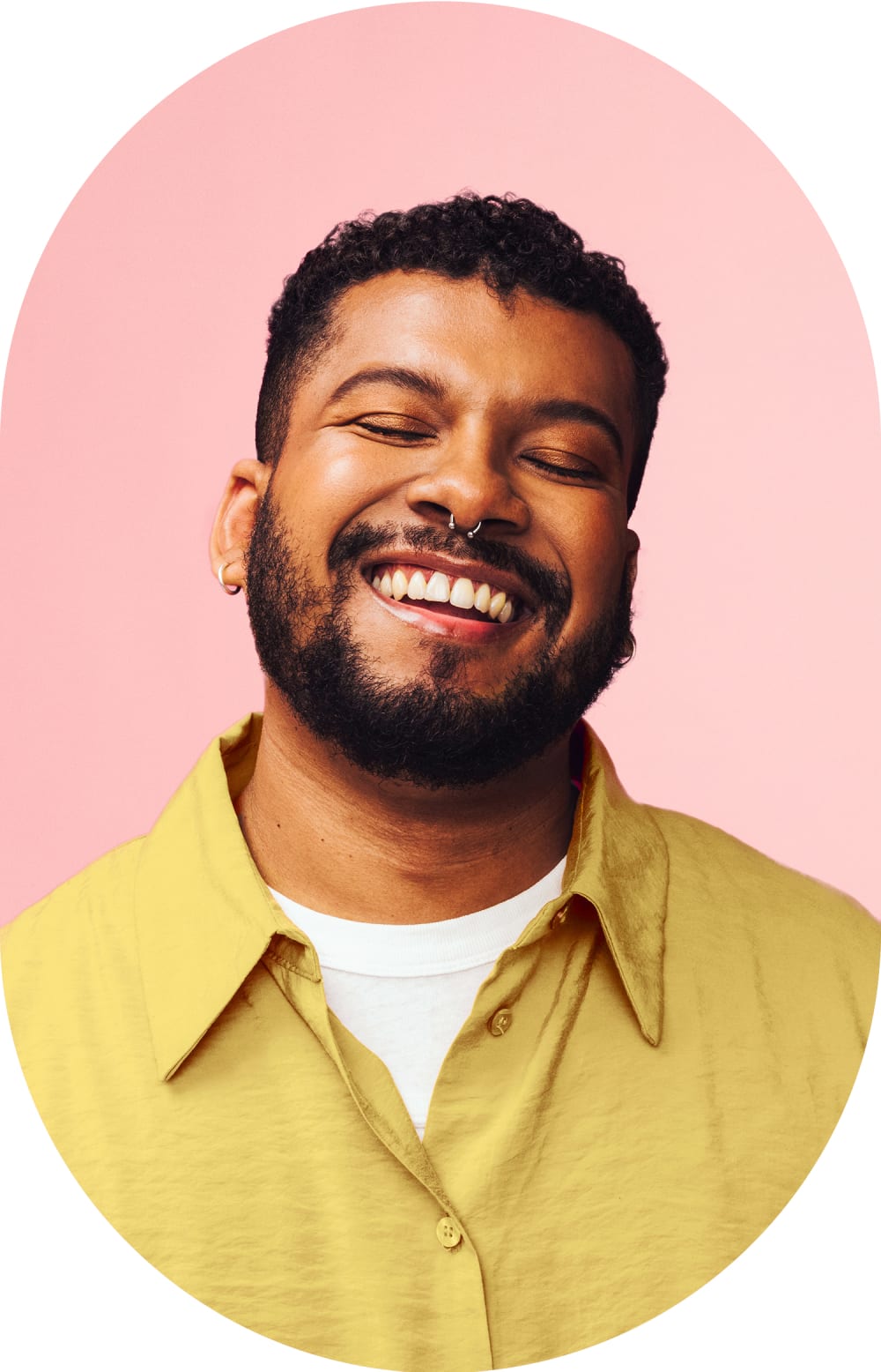 Smiling man with eyes closed, head tilted slightly upward and to his right.