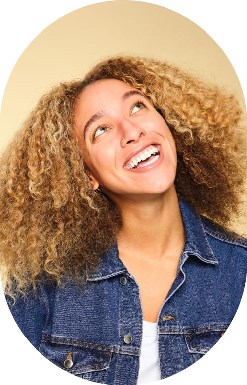 Smiling woman looking up to her left.