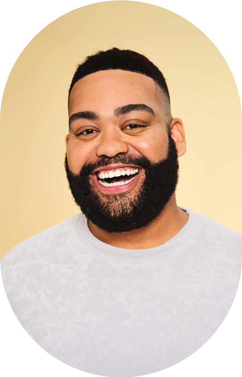 A man with a beard and short hair smiling.