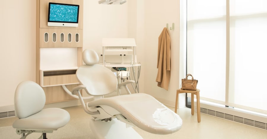 Treatment room, with treatment chair, dentists stool, and screen, clean and waiting to receive the next patient.