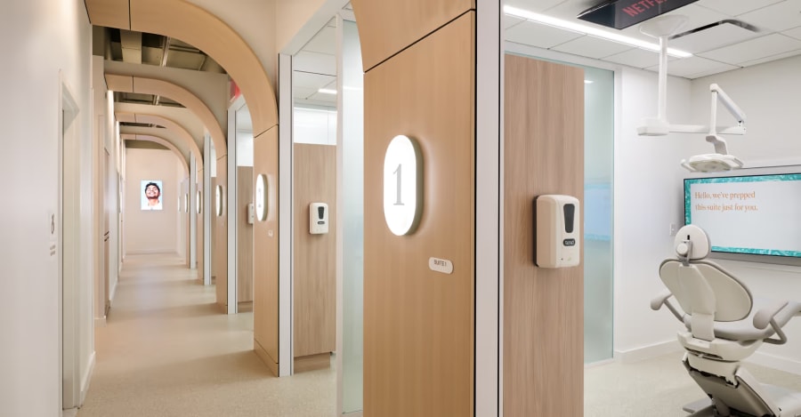 The hallway that leads patients to their treatment room, with a view inside of one treatment room to the side.