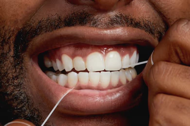 Closeup of person flossing their teeth
