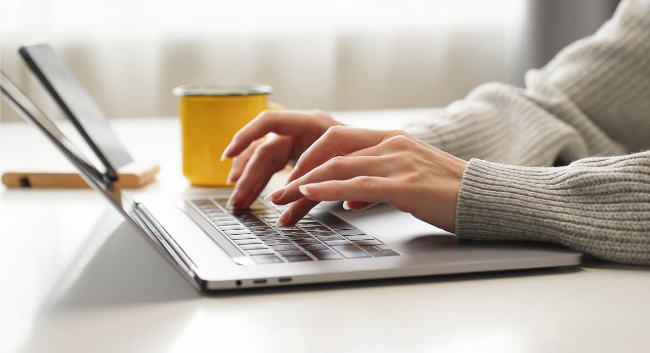 Hands type on a keyboard.