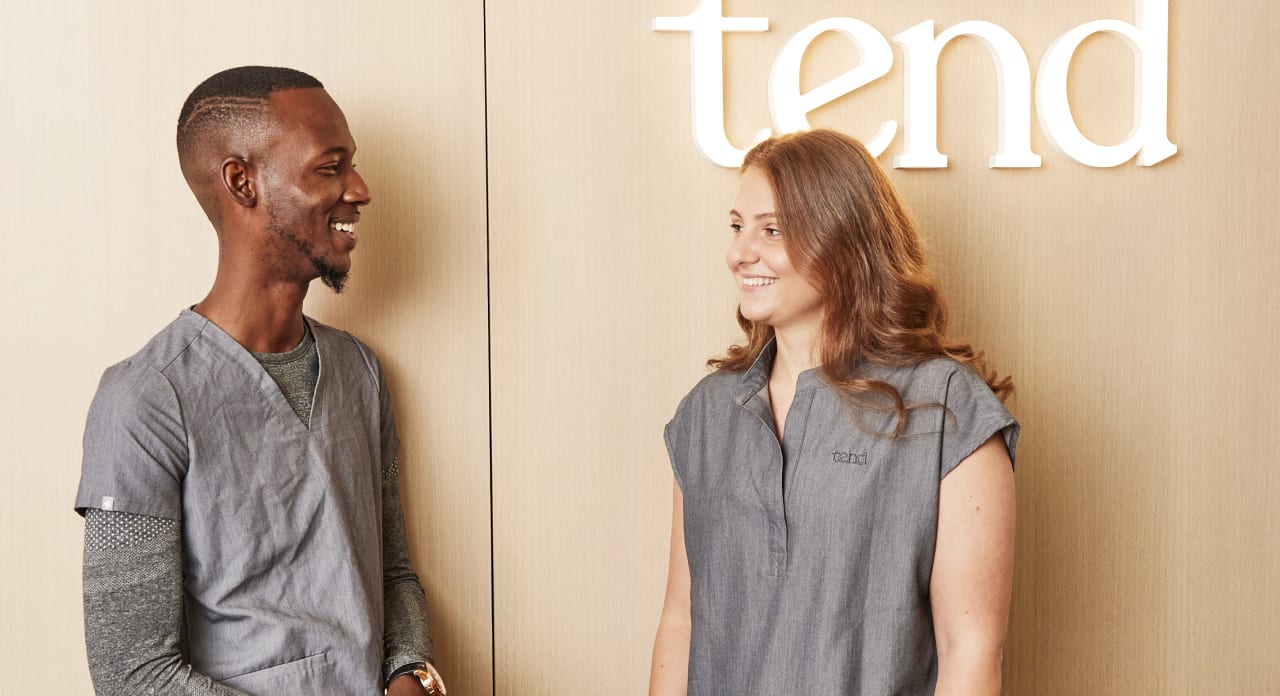 Two Tend Dental employees are chatting.