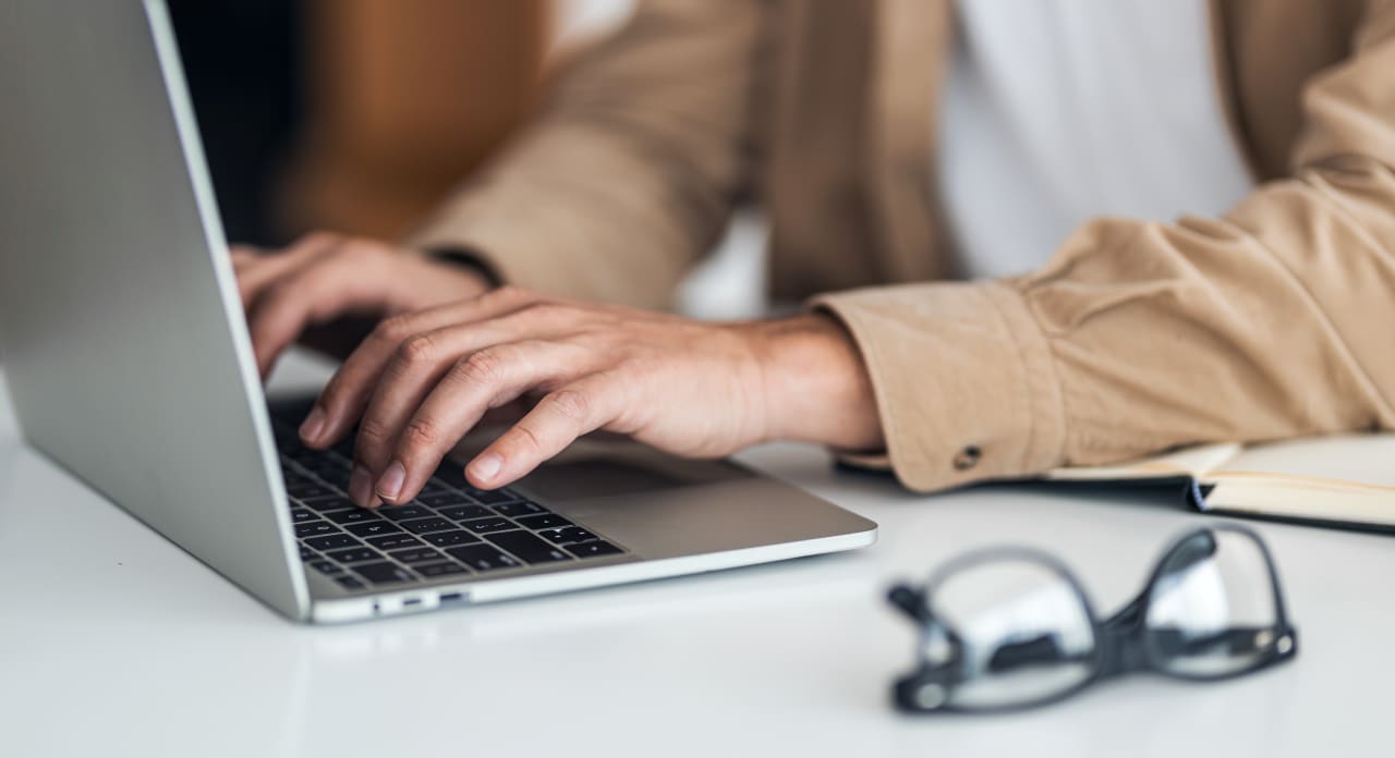Hands type on a keyboard.