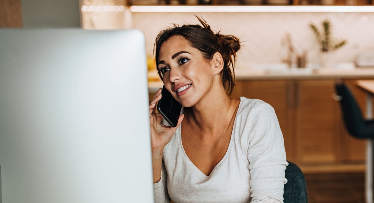 A woman is talking on the phone.