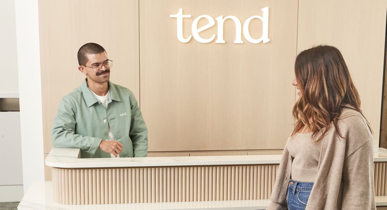 A Tend Dental employee is greeting someone in the lobby.