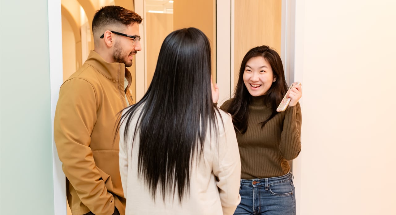Three people chat at Tend Dental.