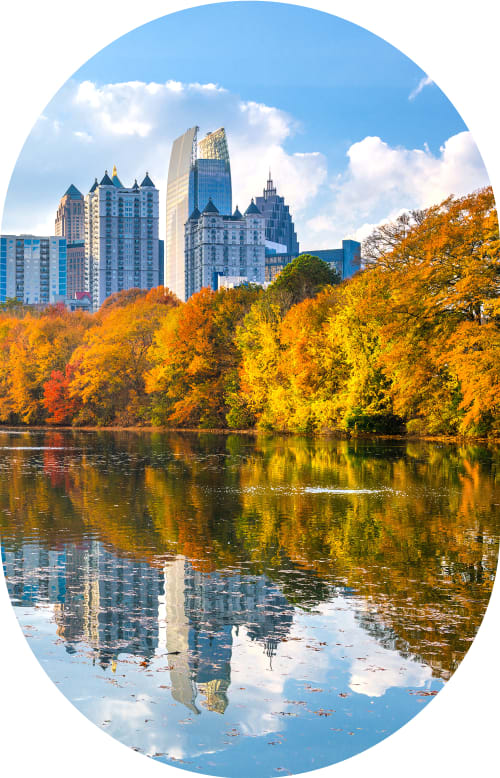 A man sits outside holding his hand to face indicating tooth discomfort.