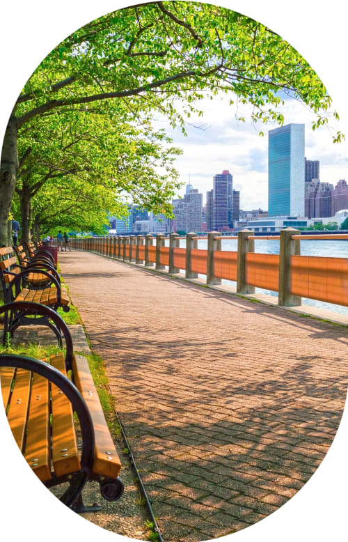 A man sits outside holding his hand to face indicating tooth discomfort.