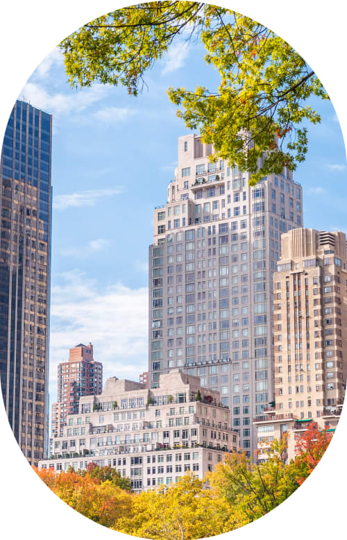 Woman stands outside smiling while wearing sunglasses.