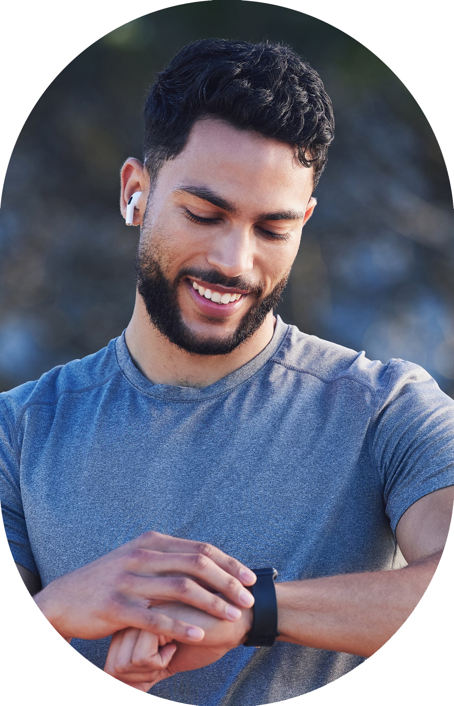 Man standing outside looking at his watch and smiling.