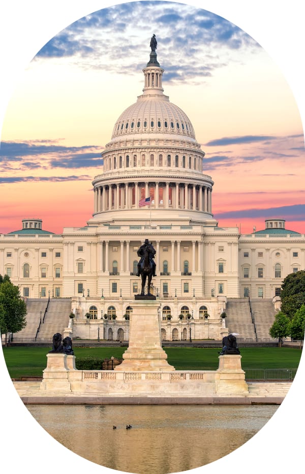 View of the White House with the sun setting behind it.