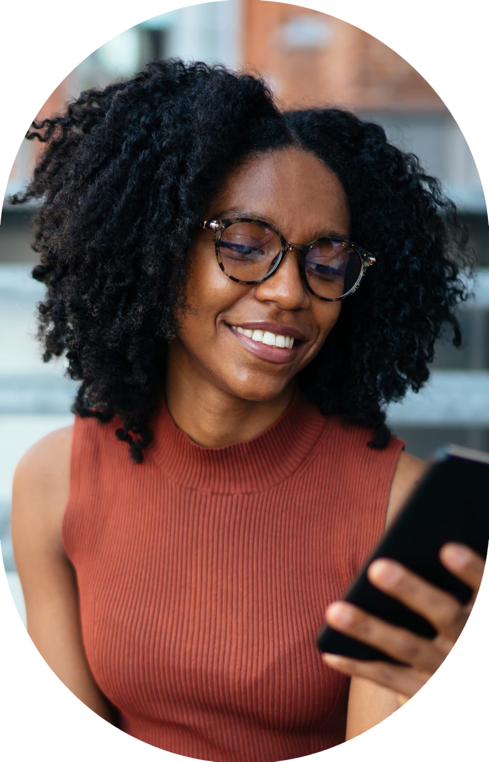 Person smiling while using their phone to manage their dental care.