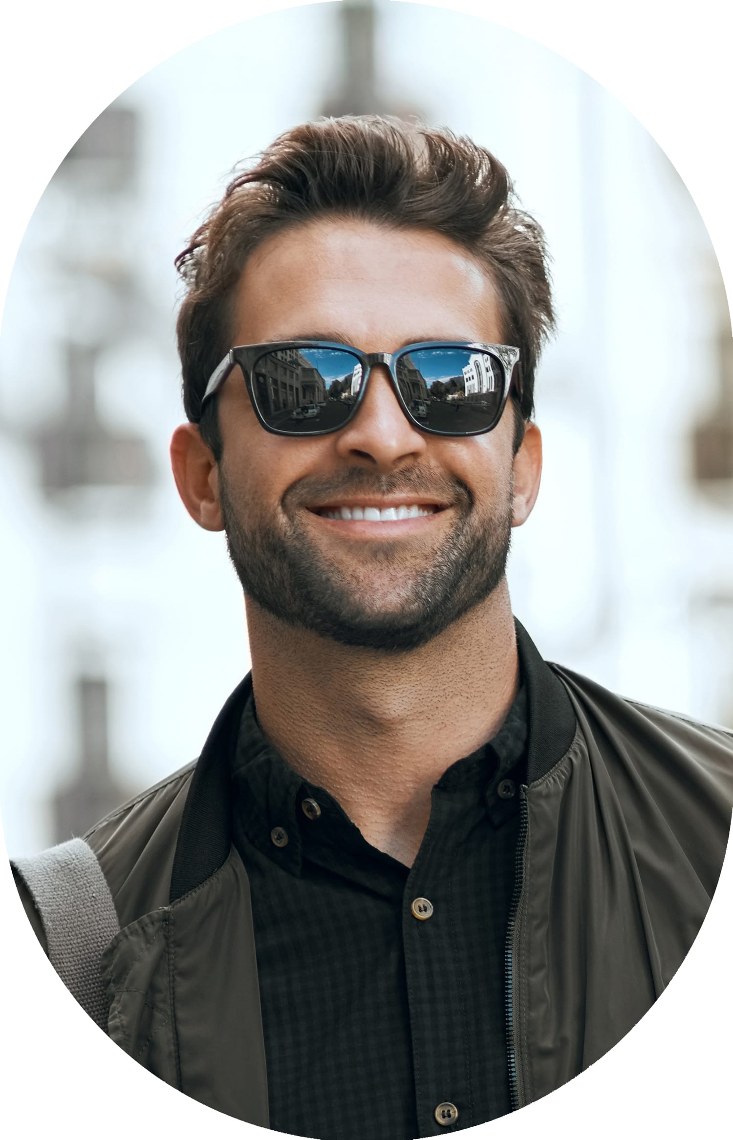 Man wearing sunglasses, smiling at the camera.