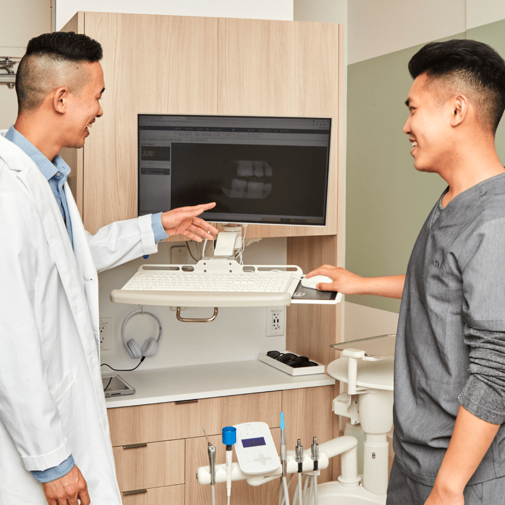 A dental professional is chatting with a colleague.