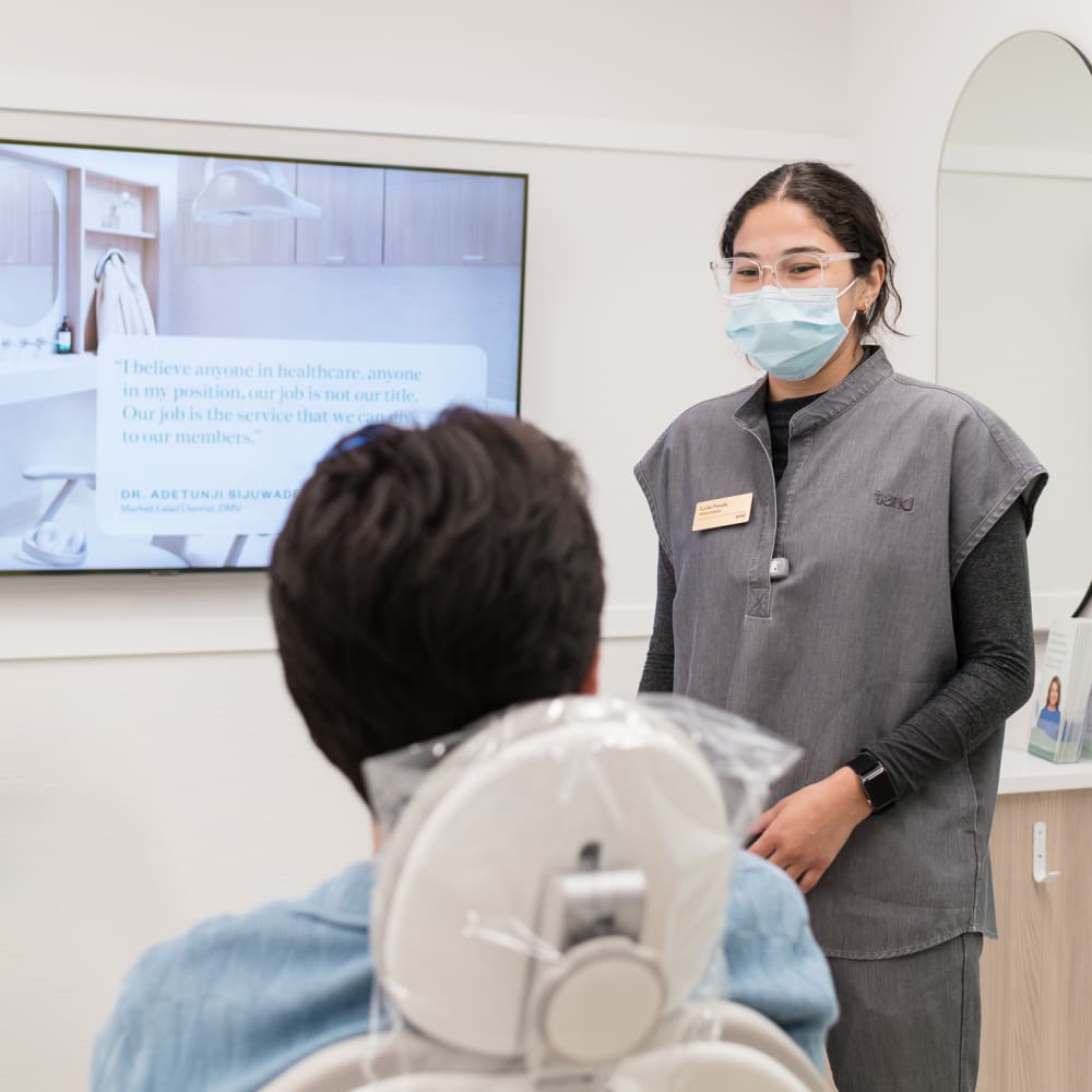 A dental professional is chatting with a patient.